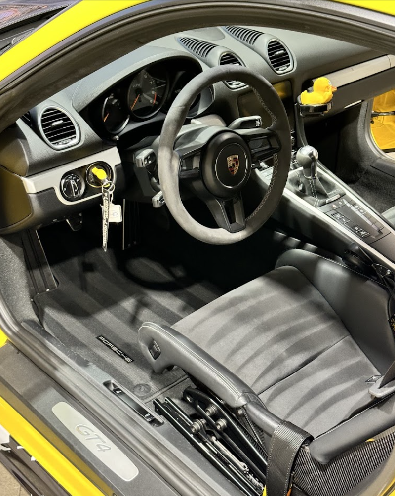 Spotless Porsche Cayman GT4 interior with detailed steering wheel and seats
