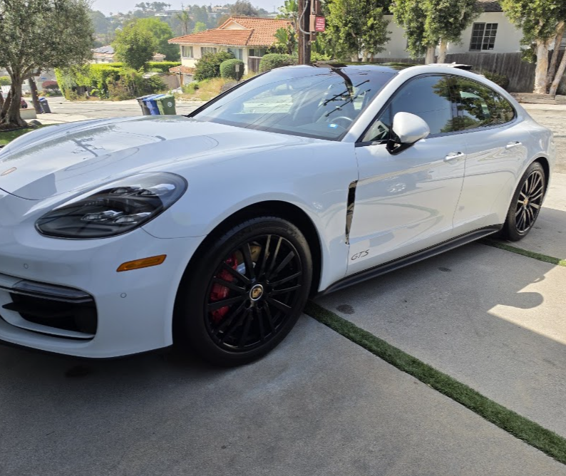 White Porsche Panamera GTS detailed and gloss-finished in a driveway